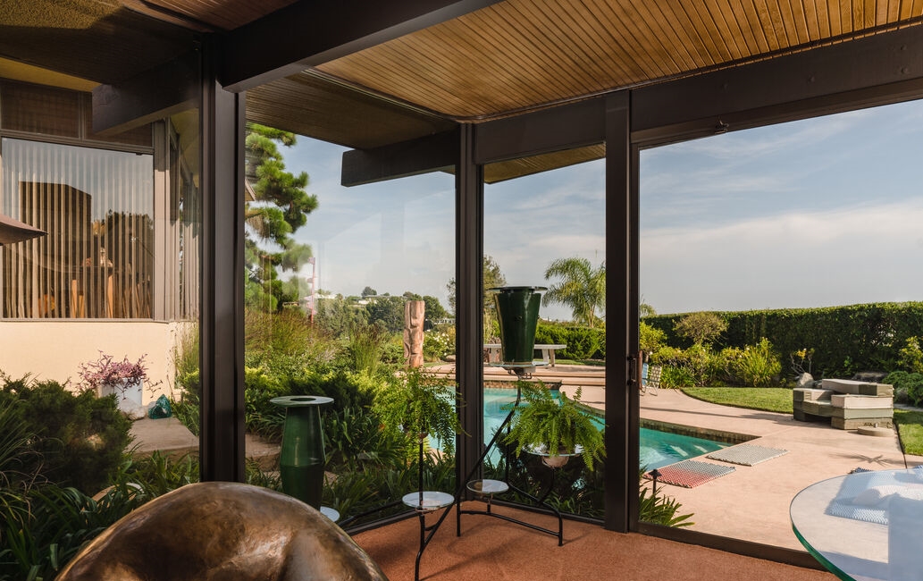 Prime Trousdale Estates Home. Fabulous living area provides for views to the pool and city and beyond.
