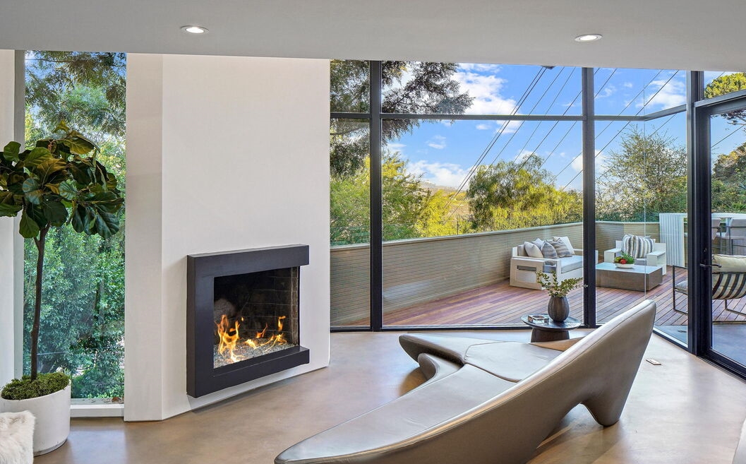 Fabulous open living room feature fabulous fireplace and a wall of glass overllooking a grand view deck.