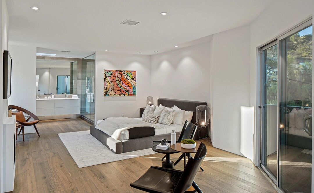 Hollywood Hills Lautner-Designed Primary suite with classic white walls with a view deck.
