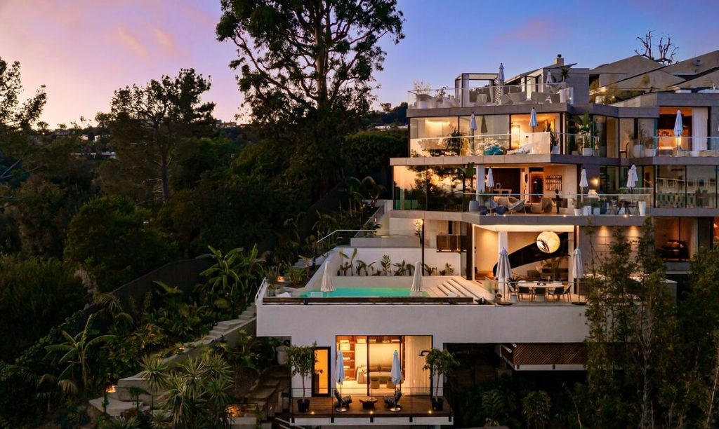 This is a Unique Hollywood Hills home by Belzberg Architects with incredible design features. Several levels of glass enclosed rooms over a pool and several scenic view decks.