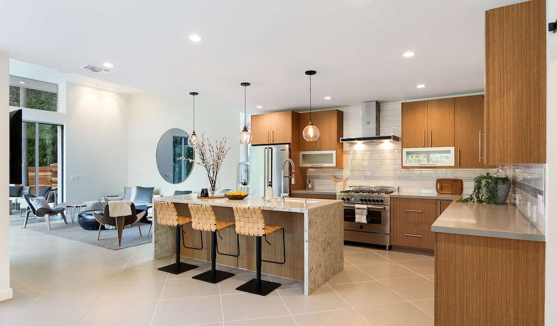 State-of-the-art Gourmet Kitchen with grand breakfast counter and opens to living area.