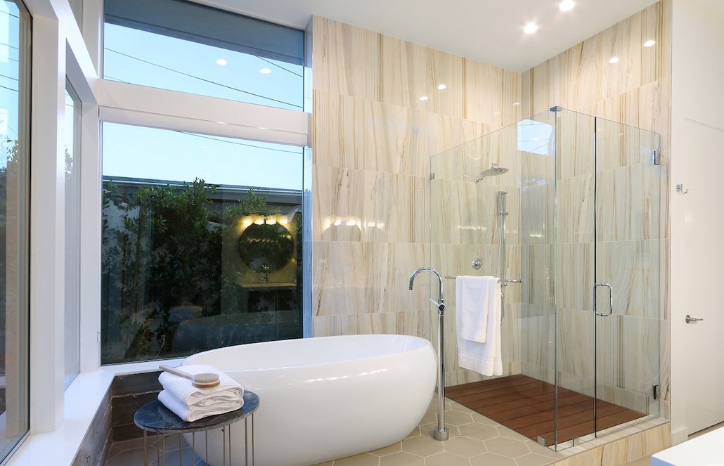 Classic white throughout the luxurious bathroom, with grand freestanding tub.