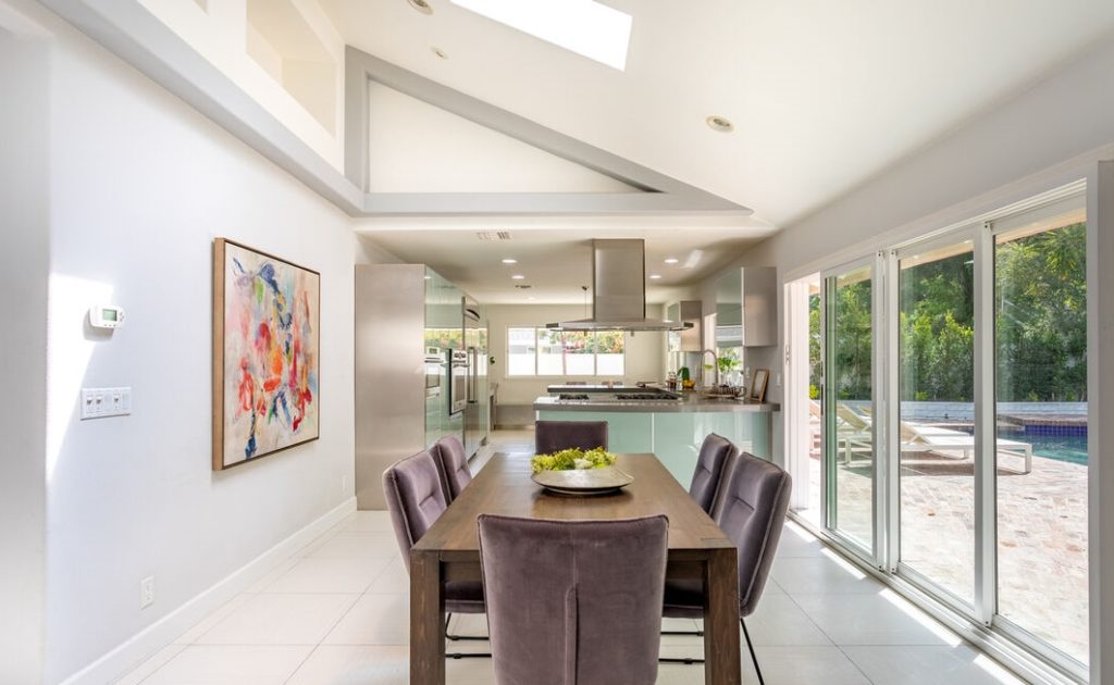 Magnificent dining room with angled ceilings and open glass walls to fabulous poolside entertainment.
