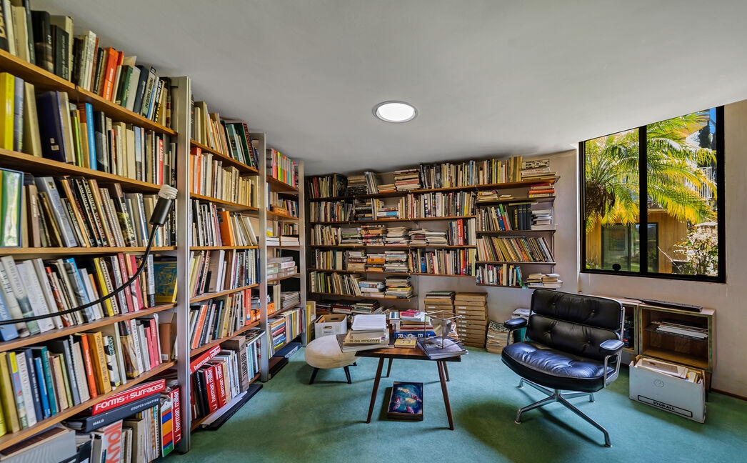 Wonderful library with walls of bookshelves, and wonderful natural light for reading.