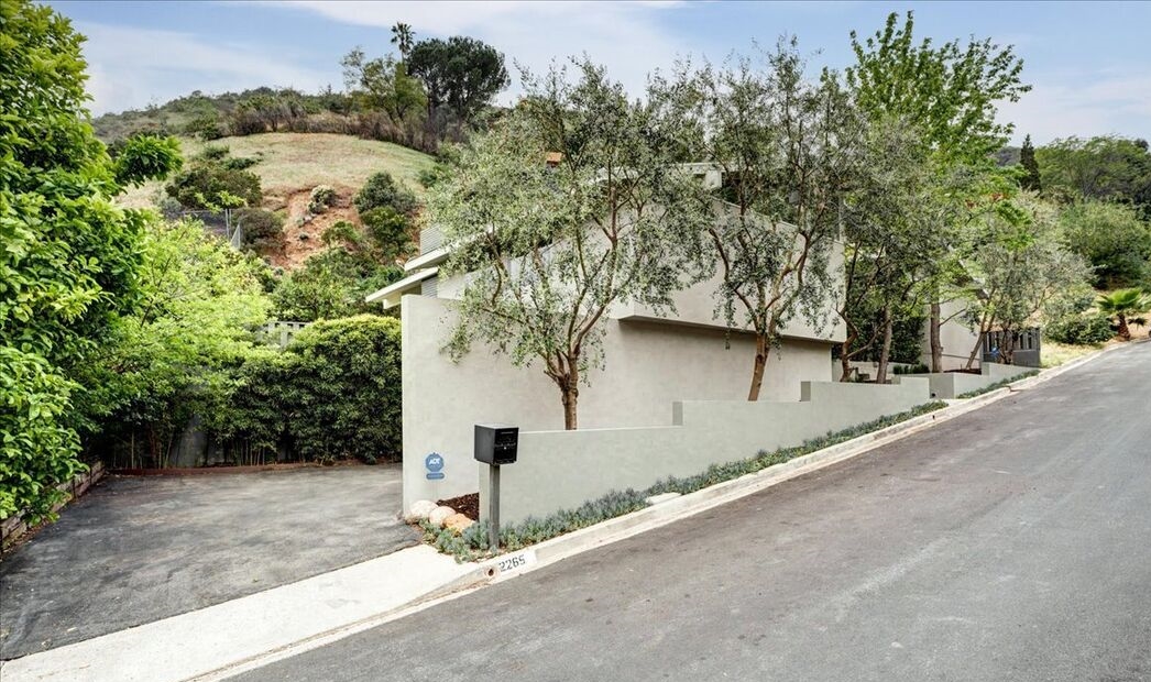 Alluring redone mid-century with hillside and some city light seasonal views located of the Hollywood Hills.