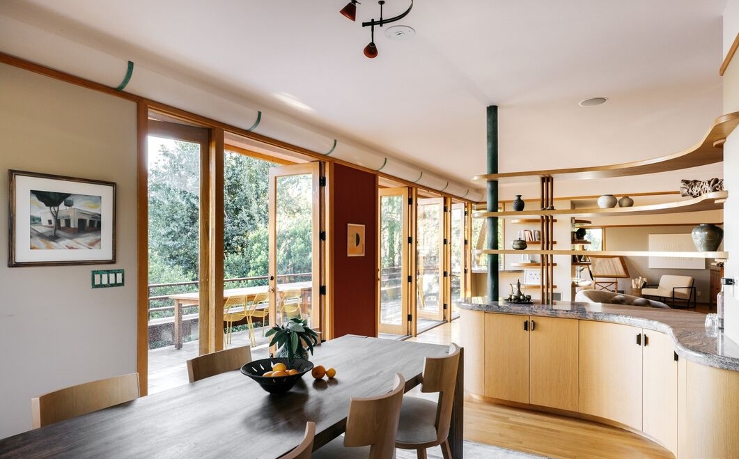 With its rich original wooden cabinetry, the partially vaulted kitchen incorporates a two-story mitred window, skylights, and clerestory windows. 