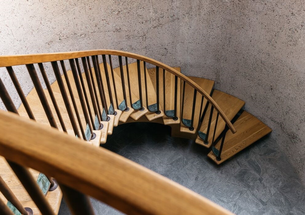 A breathtaking sweeping entry comprised of curved aggregate concrete with dramatic staircase.