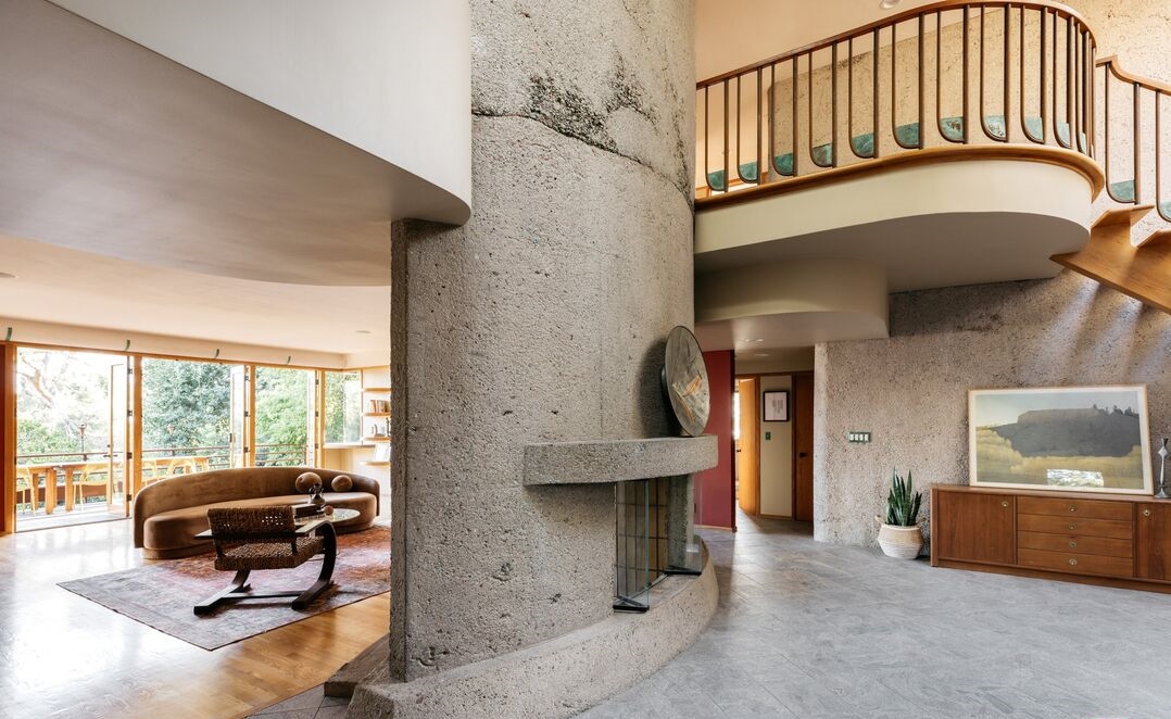 La Crescenta Eric Lloyd Wright A large living area, open office/den and dining room are anchored by a two-story oval concrete fireplace
