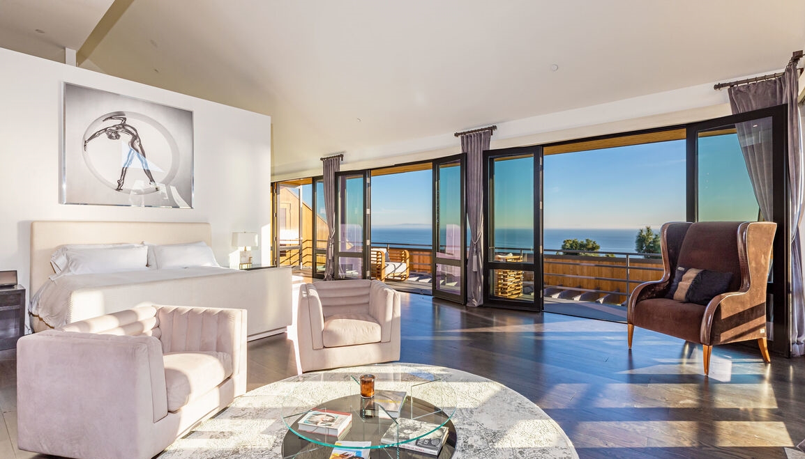 The primary suite has incredible ocean-views, a woodburning fireplace, luxurious bathroom.