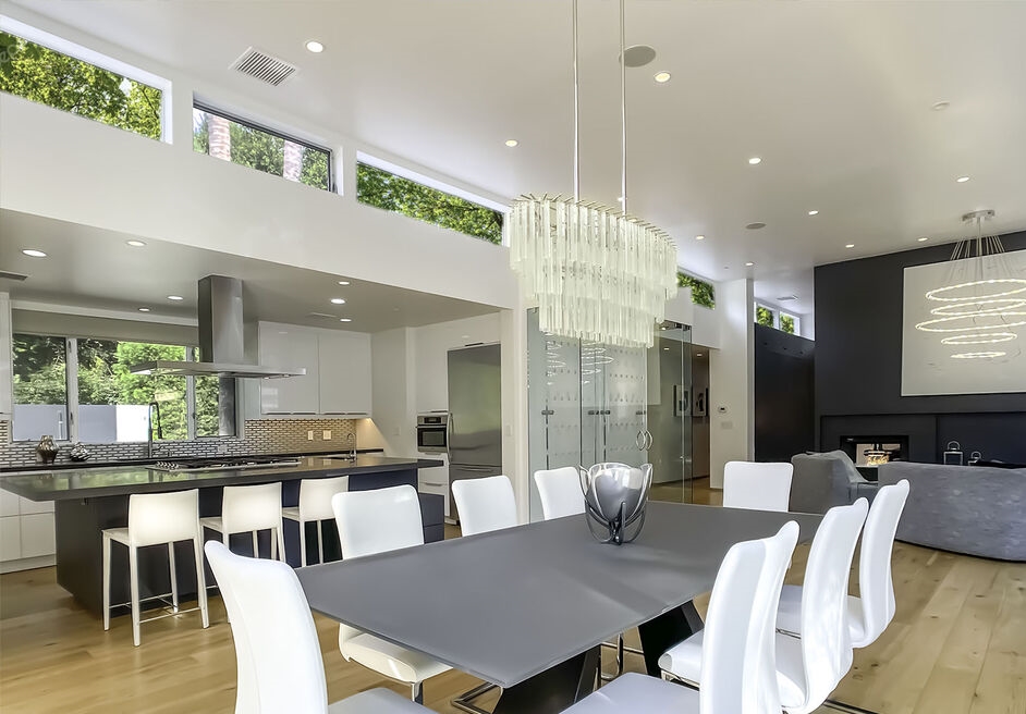 Fabulous dining area opens to the chef's kitchen and white walls and windows everywhere bringing in an abundance of natural light.