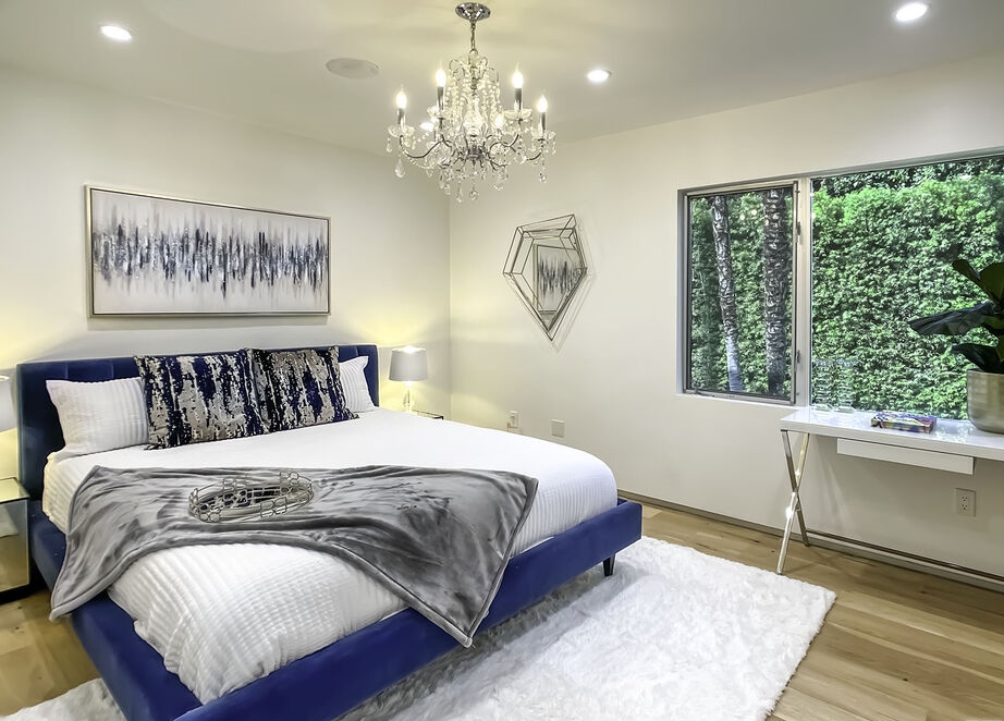 Prime location Encino Rancho Estates!  Lovely secondary bedroom with fabulous chandelier. Abundance of light through walls of windows.