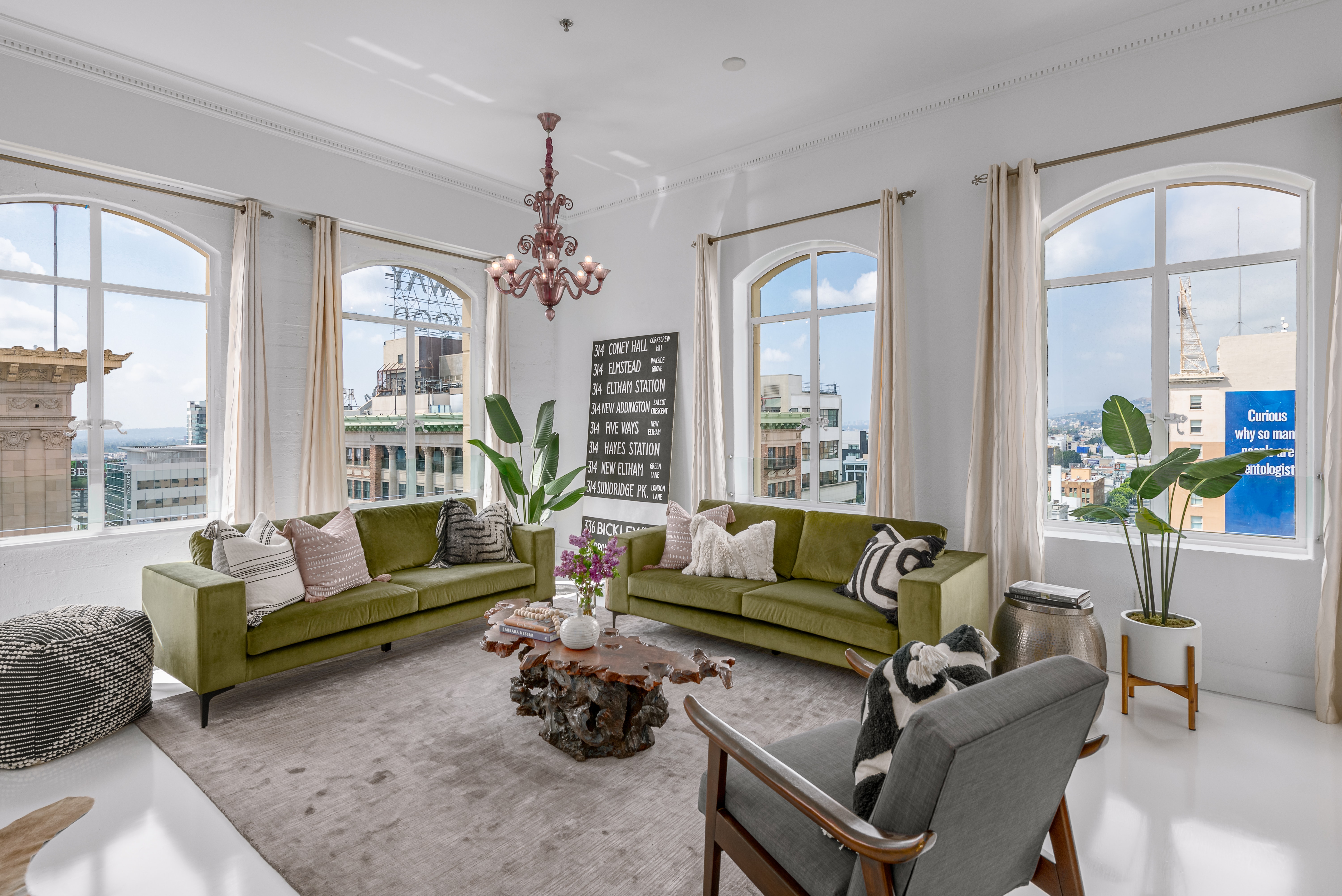 Stunning living area with arched windows looking out to breathtaking city views.