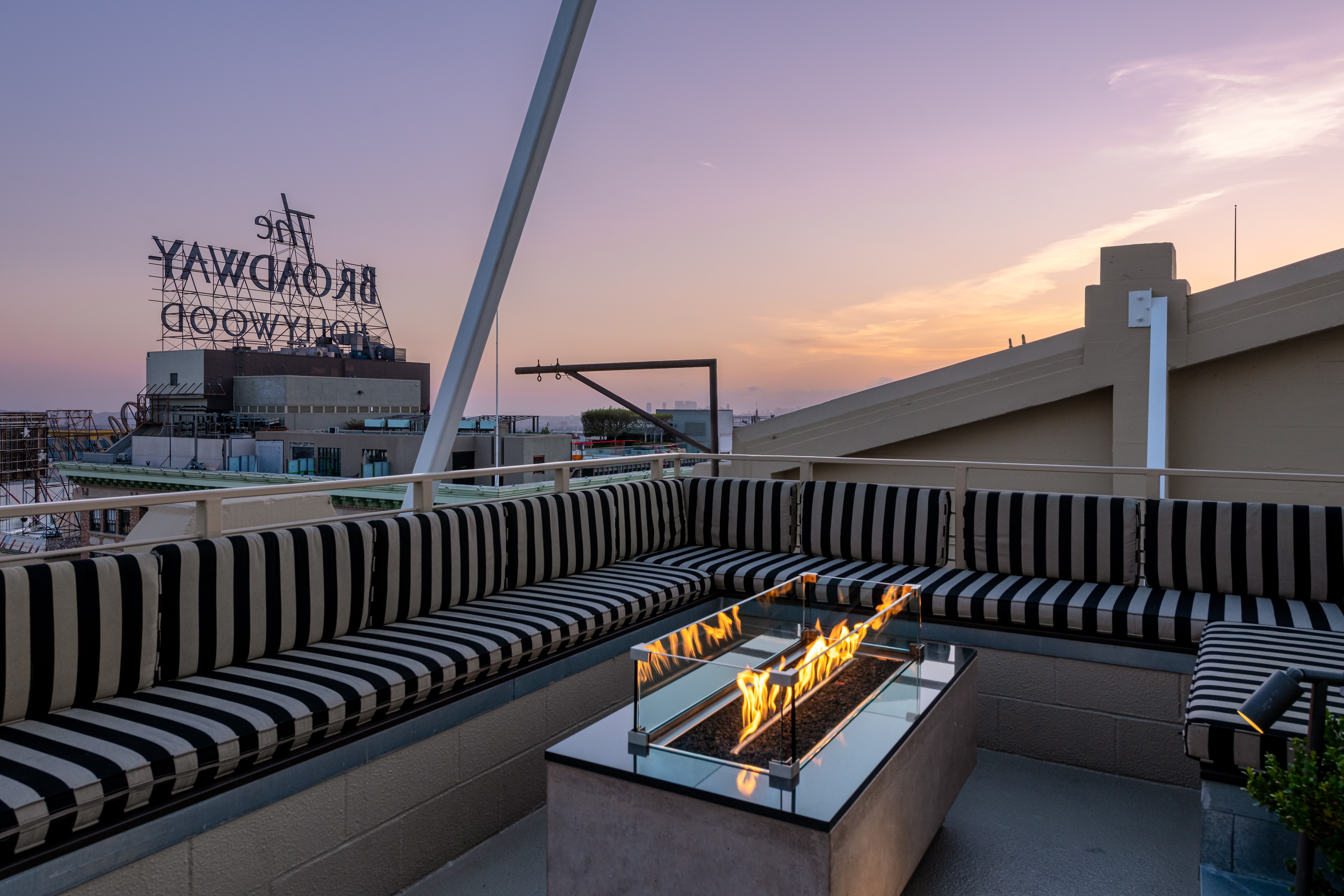 Historic Lofts at Hollywood. Cozy seating and firepits to enjoy breathtaking city views from this magnificent roof top patio area.