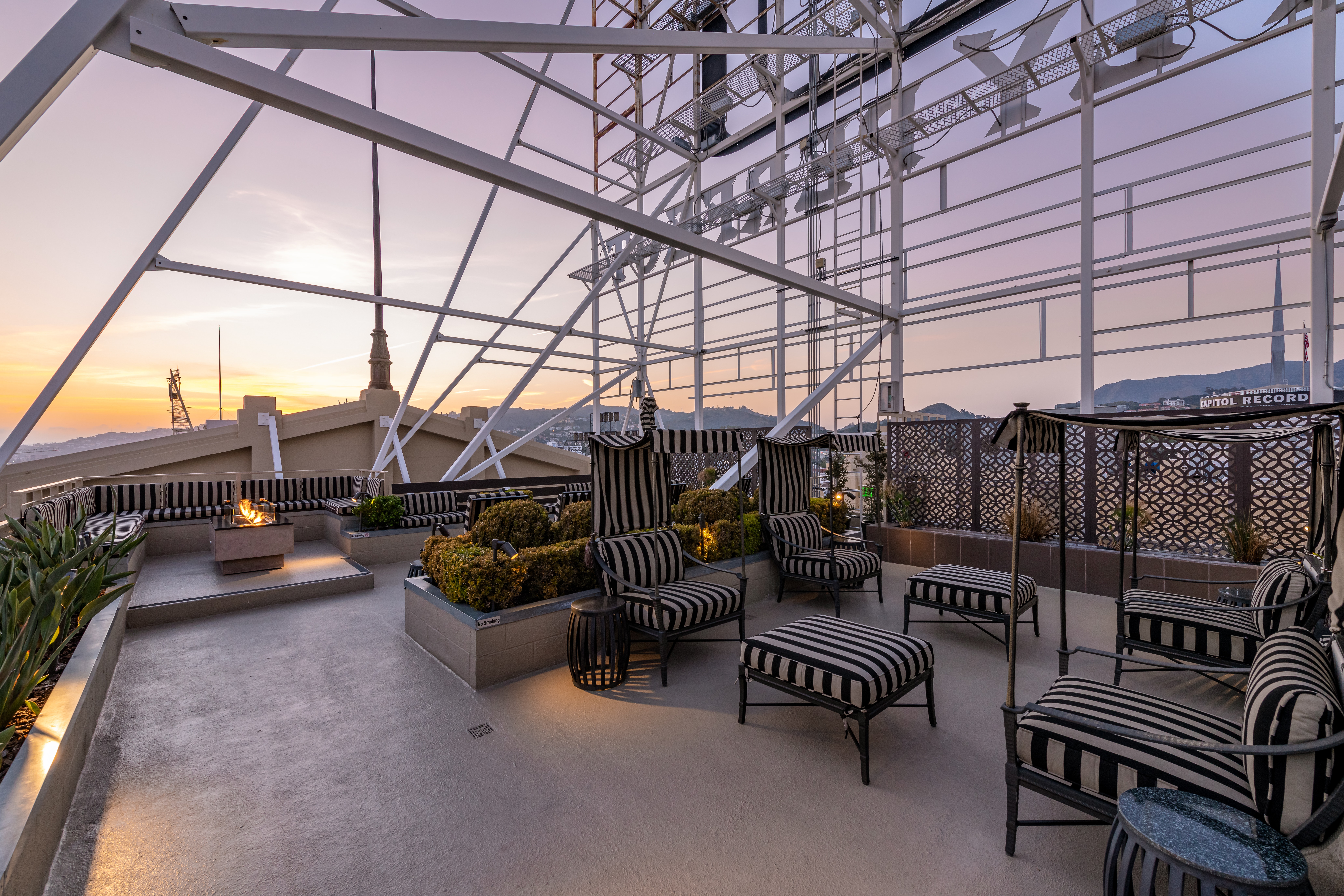 Historic Lofts at Hollywood. Cozy seating and firepits to enjoy breathtaking city views from this magnificent roof top patio area.
