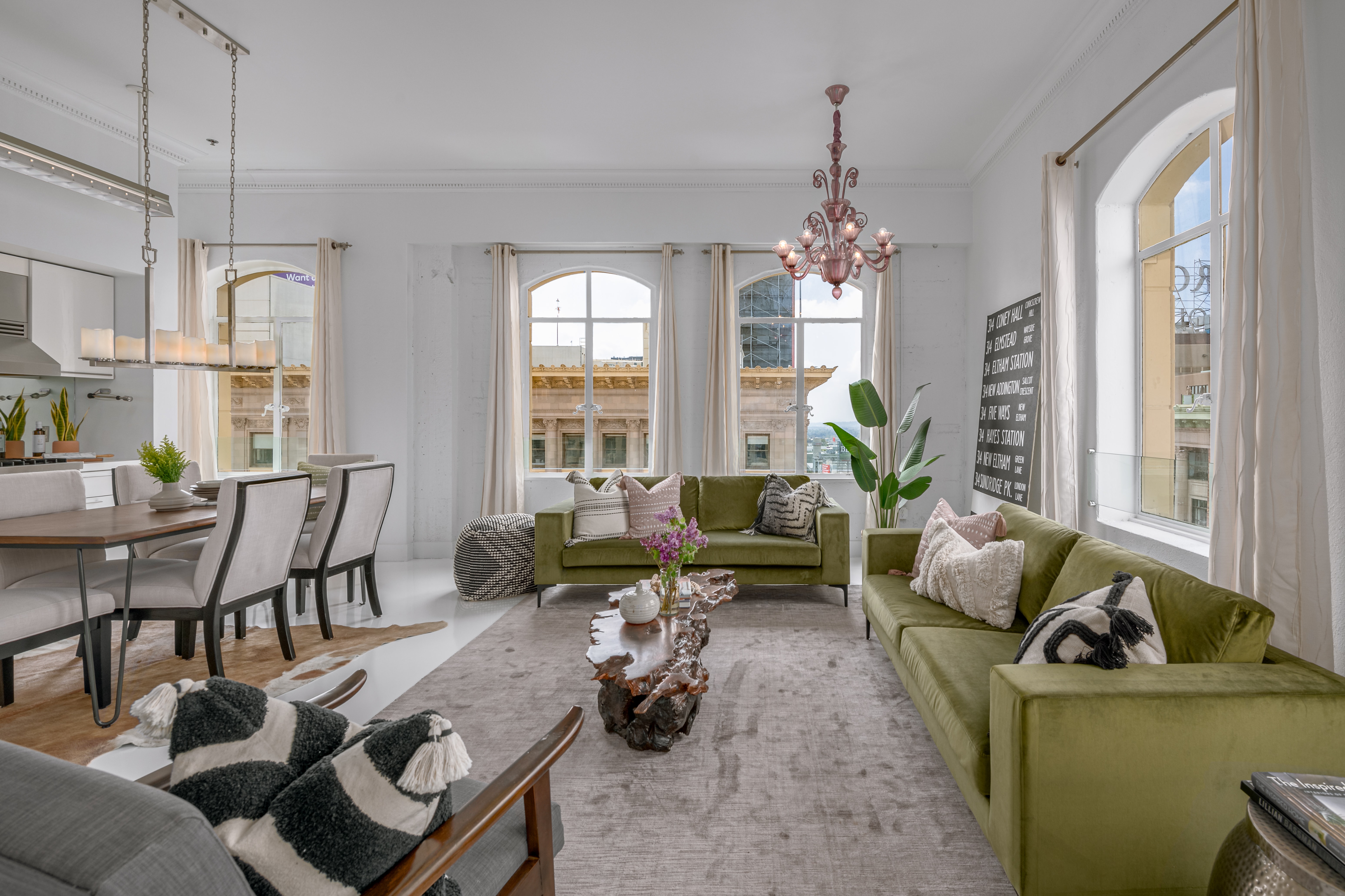 Stunning living area with arched windows looking out to breathtaking city views.