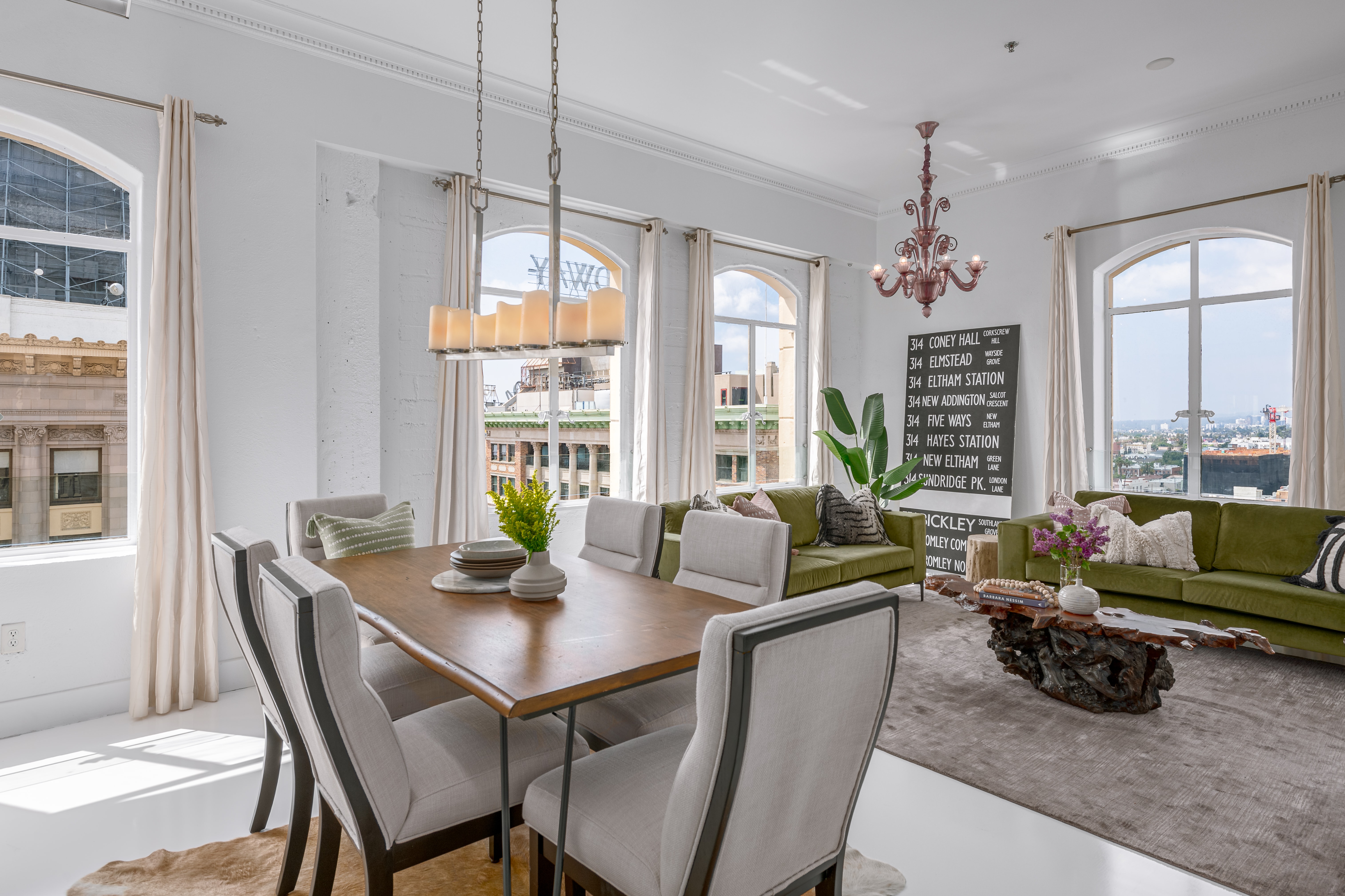 White walls, decorative lighting and archways embrace the formal dining room. Opens to living area.