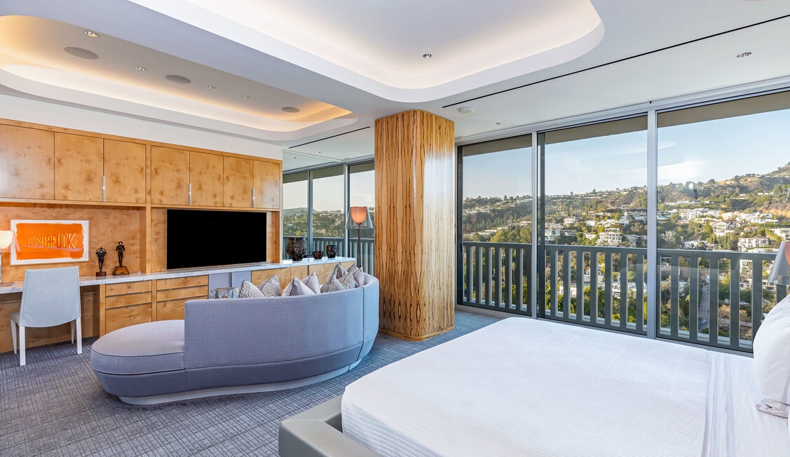 One of three grand bedroom suites, impeccably crafted cabinetry and jetliner views.