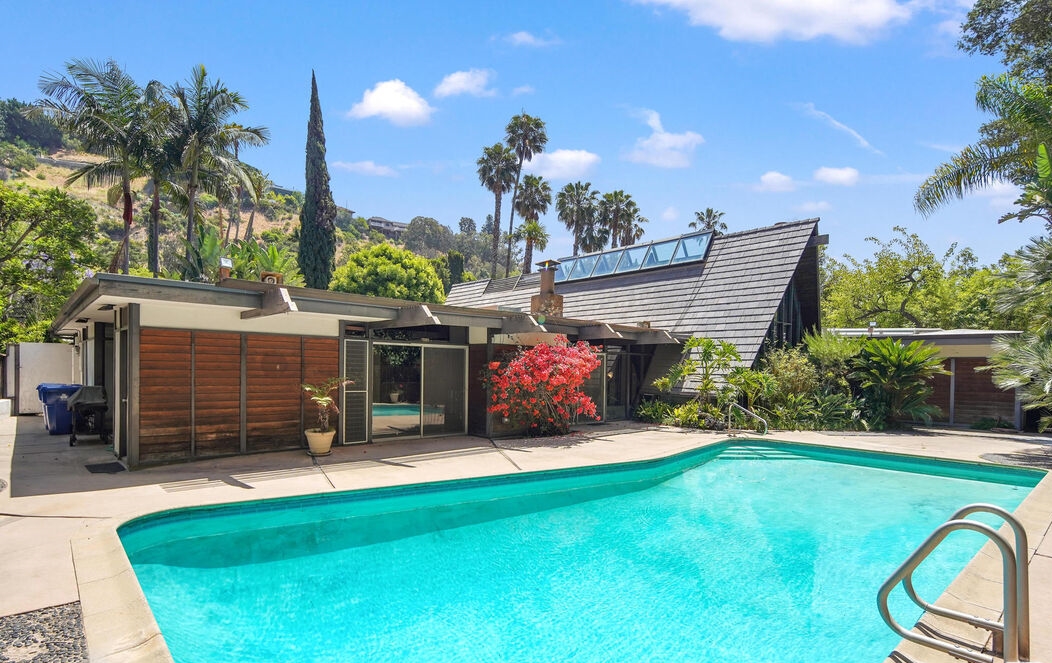 Beverly Hills Architectural A-Frame features a huge sparkling pool in the rear yard.