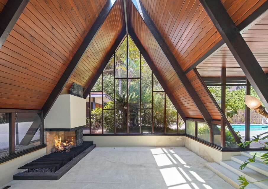 Incredible A-Frame lines and walls of glass in this living room with amazing inground fireplace.