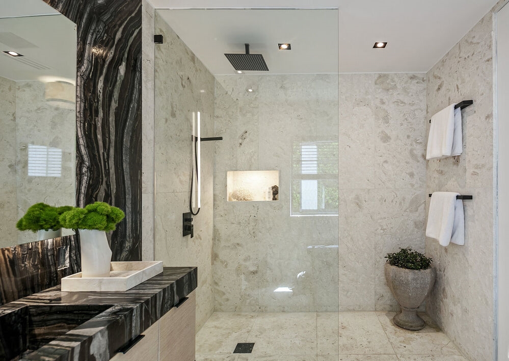 Remarkable primary bathroom with large glass enclosed shower.