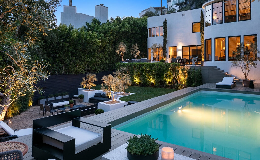 Breathtaking poolside view to this remarkable Moderne home.