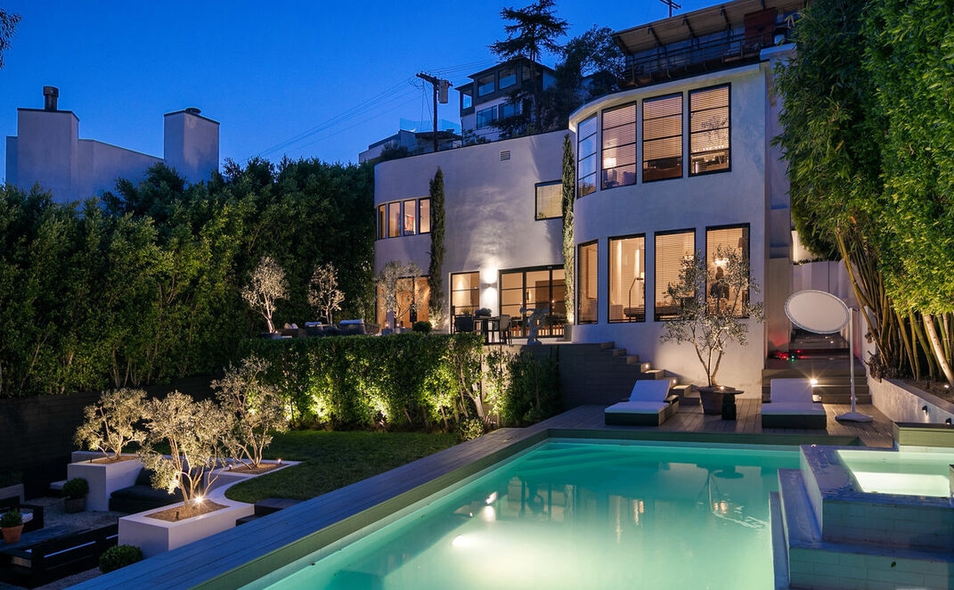 Breathtaking poolside view to this remarkable Moderne home.