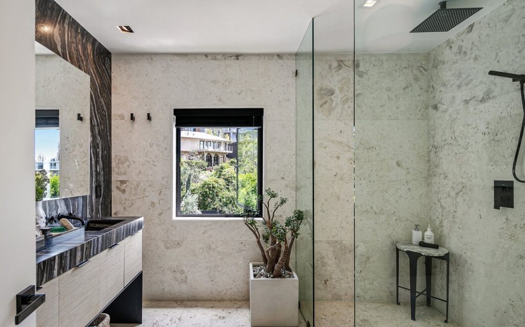 Remarkable primary bathroom with large glass enclosed shower.