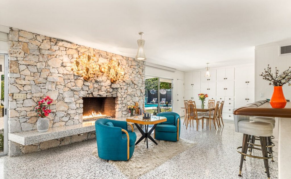 Palm Springs Quintessential living room with Massive Stone faced fireplace overlooks pool yard