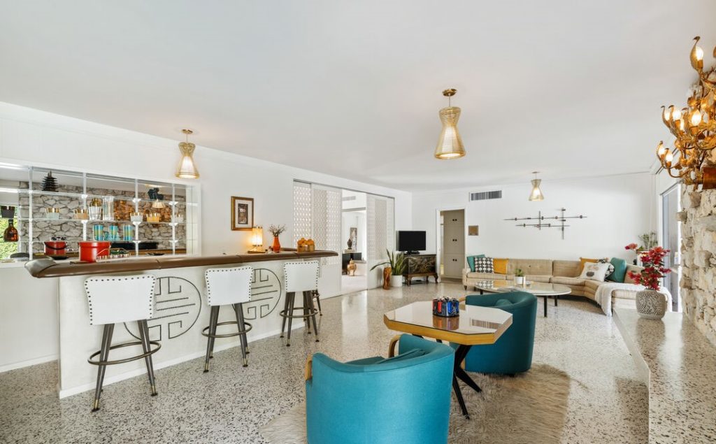 Palm Springs Quintessential living room with Massive Stone faced fireplace and grand wet bar