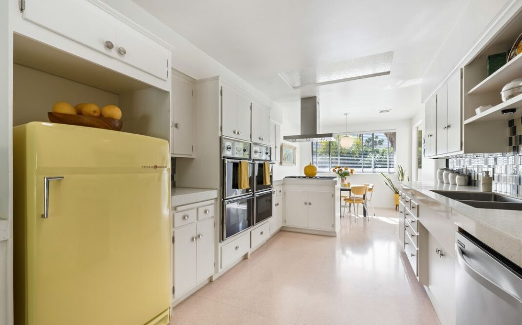 Remarkable period kitchen restored yellow refrigerator from 1959, custom built in cutting boards and outdoor access.