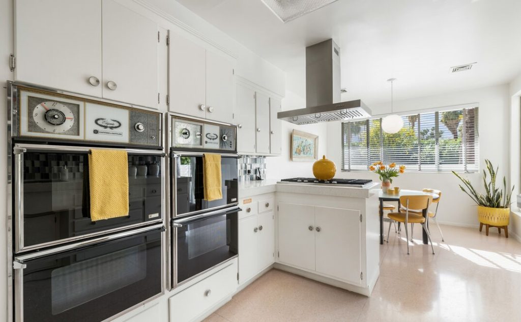 Remarkable period kitchen restored yellow refrigerator from 1959, custom built in cutting boards and outdoor access.