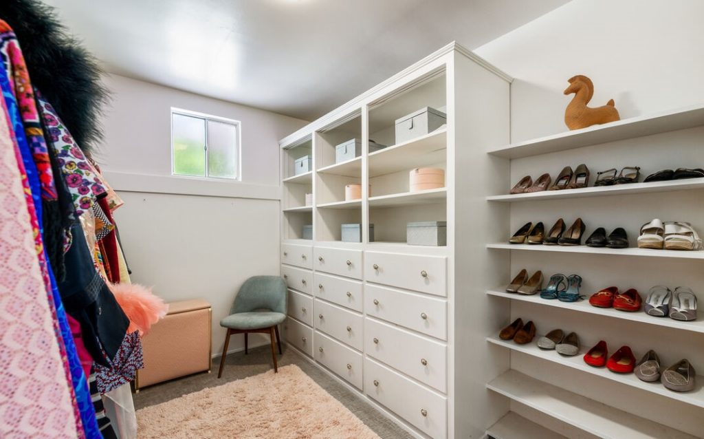 Massive primary closet with walls of custom built-ins