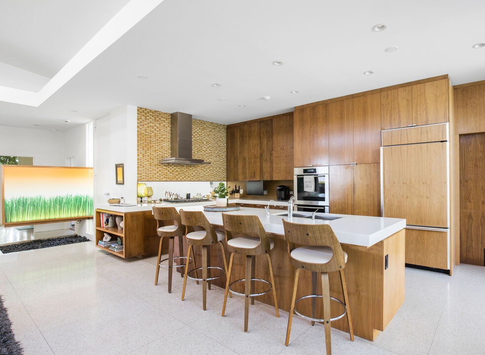 Holmby Hills 1958 Hal Levitt Reimagined by Assembledge+ creative kitchen design with large breakfast bar.