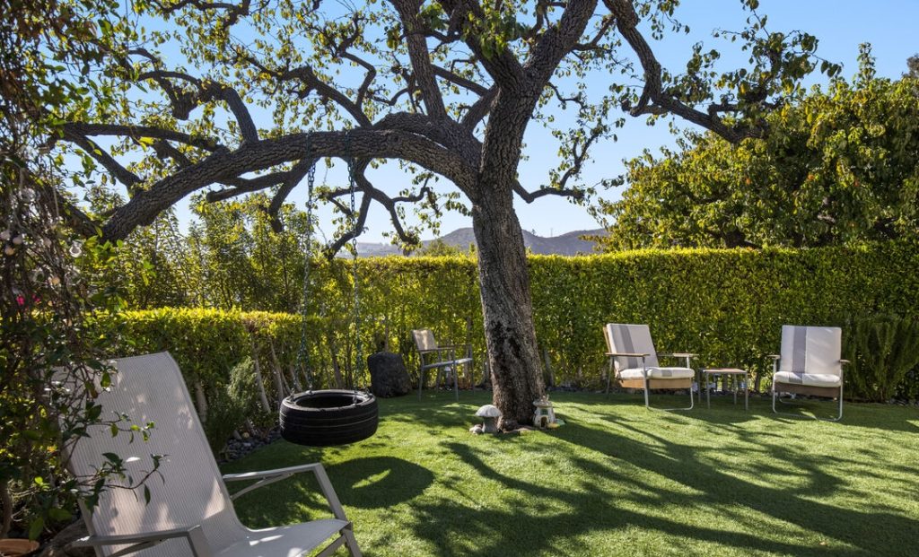 Fabulous lush grounds enhance the rear yard.