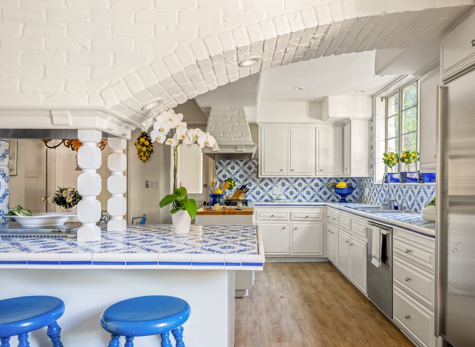 Magnificent Luxury Spanish huge open kitchen all white walls with brick arched accents and custom cornflower blue and white tile