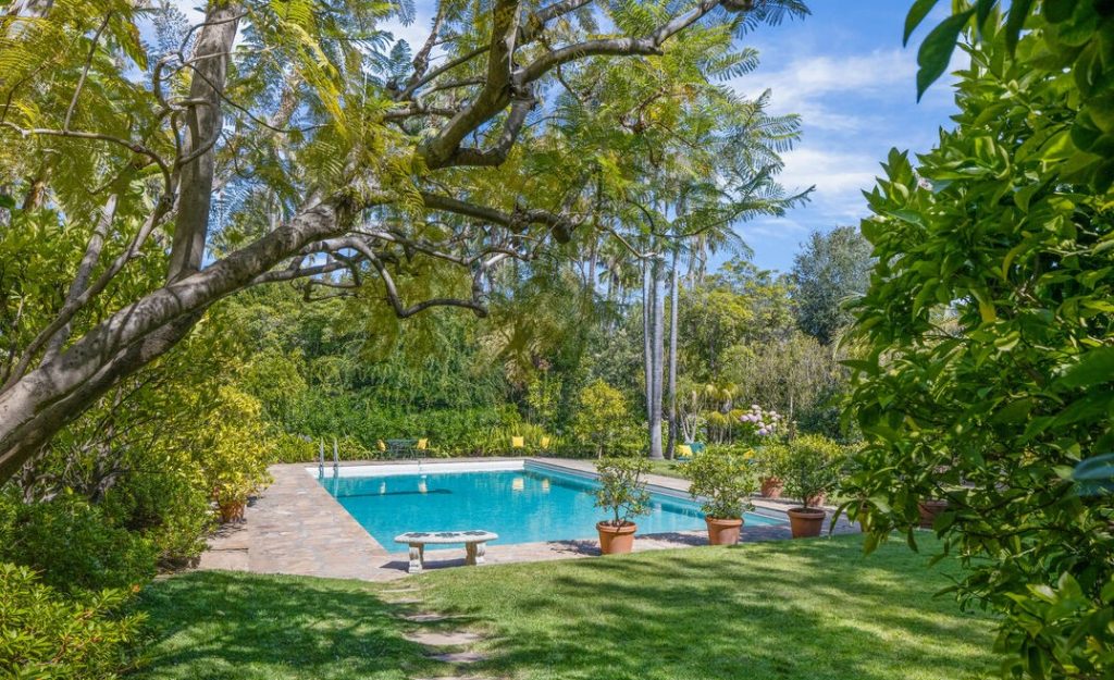 Bel Air Luxury Spanish the Ernst Lubitsch Estate features a Remarkable Grand Pool and lush rear yard.