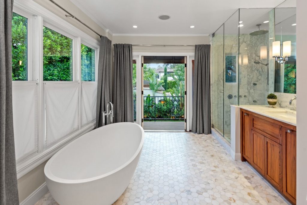 Remarkable free standing tub and glass enclosed shower, and walls of windows