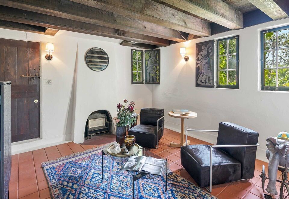 Spanish Architectural with remarkable wood beam ceilings in large living area.