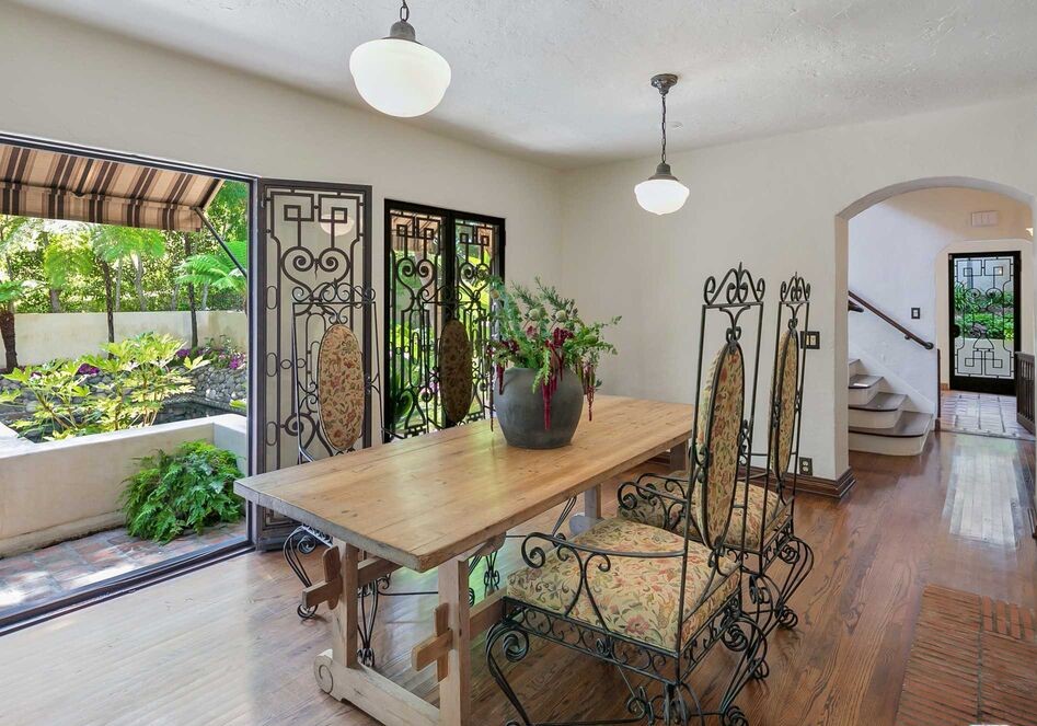 Grand formal dining room opens to lush grounds and outdoor areas
