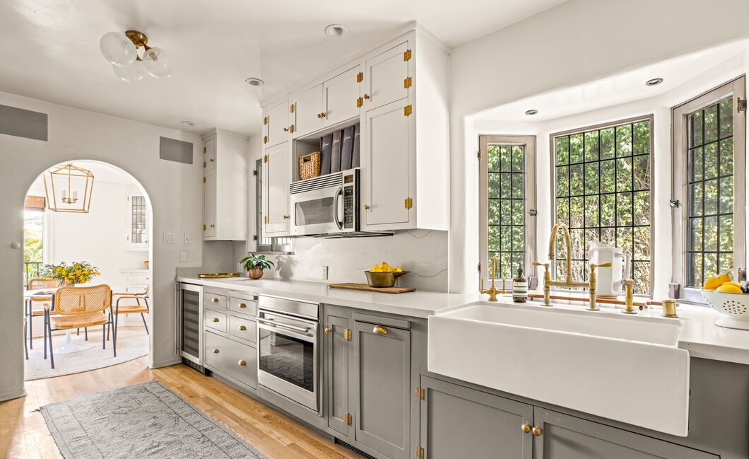 The chef-inspired kitchen boasts quartz marble countertops, stainless steel appliances, wine refrigerator, and custom cabinetry 