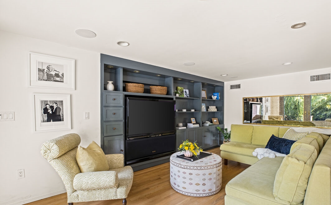 Large cozy living room provides a wall of entertainment cabinets.