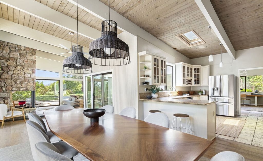 Remarkable open kitchen with gorgeous countertops, wood ceilings and skylights, opens to dining room.