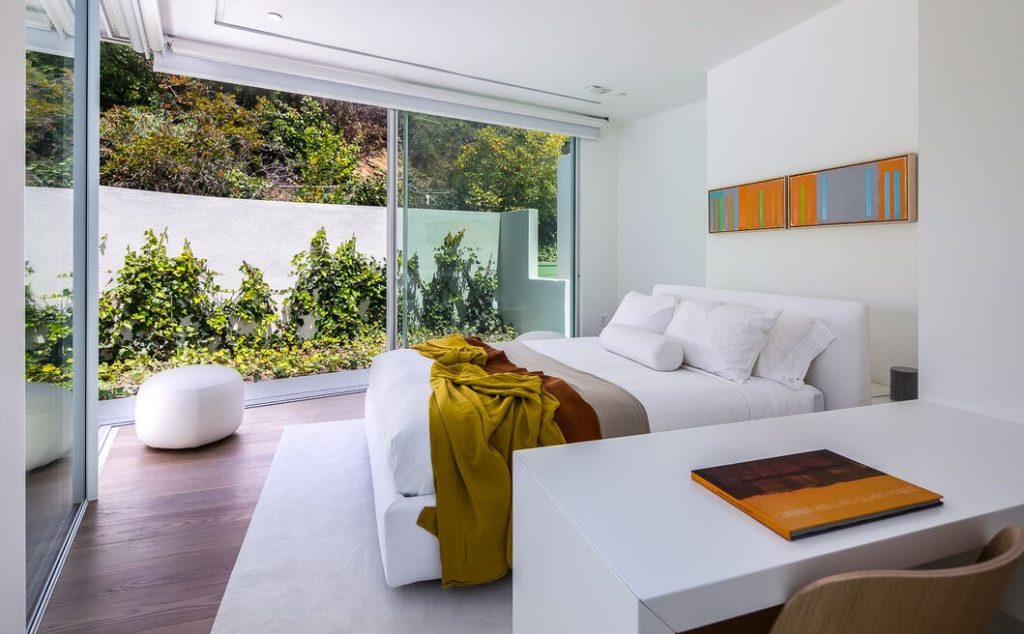 Spacious secondary bedroom with a wall of glass to the outside.