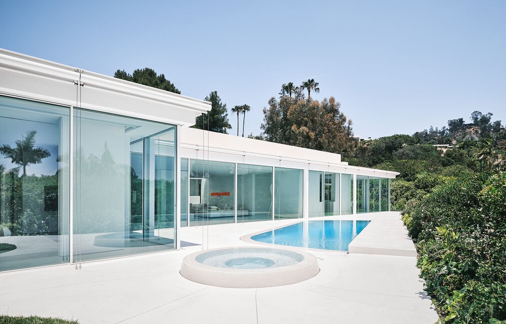 Walls of glass open to this spectacular pool yard in the architectural gem