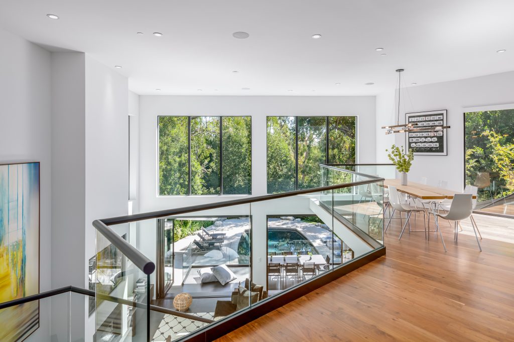 Brilliant breakfast room design with glass walls overlooking overlooking living below.