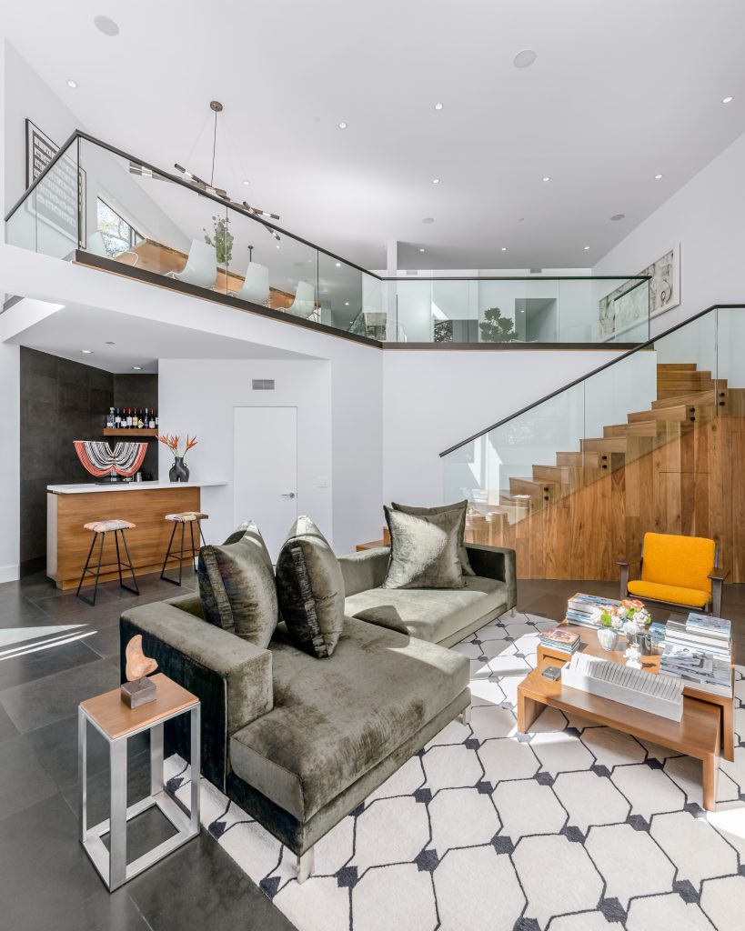 Fabulous living room grand space with multi levels in the design glass walls from above overlooking it all