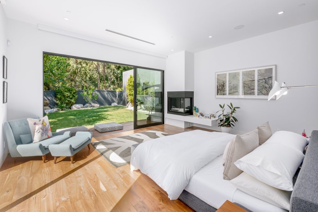 Amazing primary suite opens right out to the private sun deck and lush rear yard