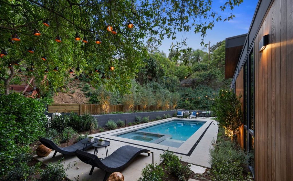 Dynamic pool yard surround by lush landscaping