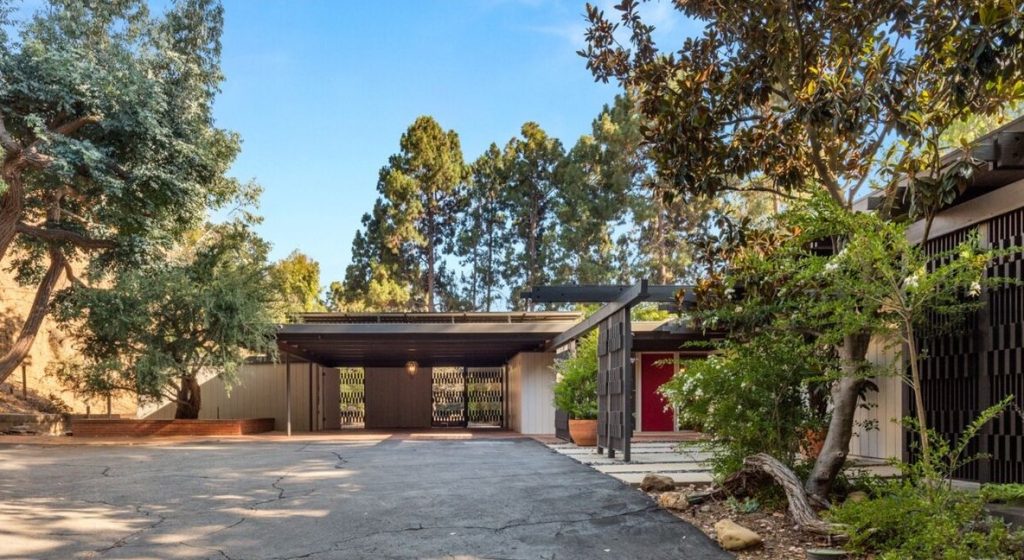 Grand driveway and entry. Remarkable design and architecture is highlighted by brilliant wood beamed ceilings throughout the entire home.