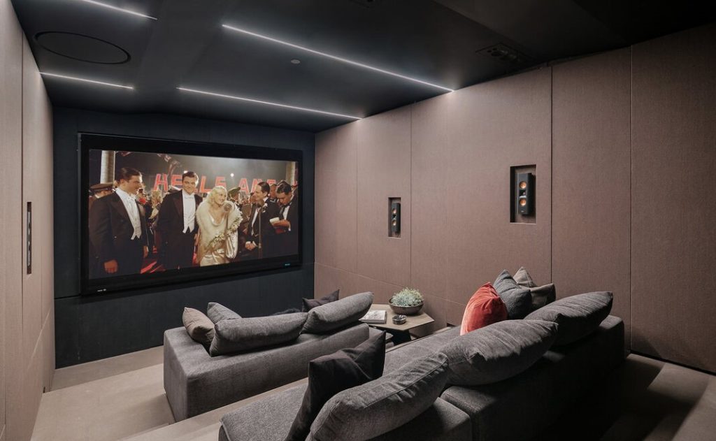 the felt wall and cork floor home theatre that is designed with luxury minimalistic aesthetics